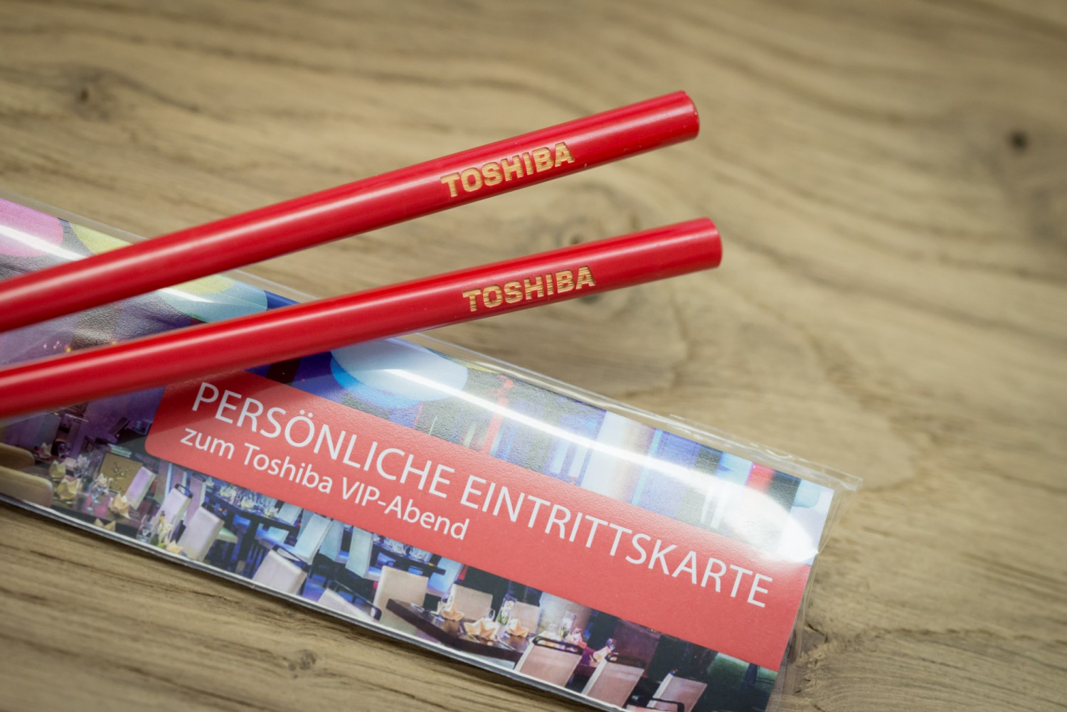 red chopsticks with laser engraving as invitation to a VIP event