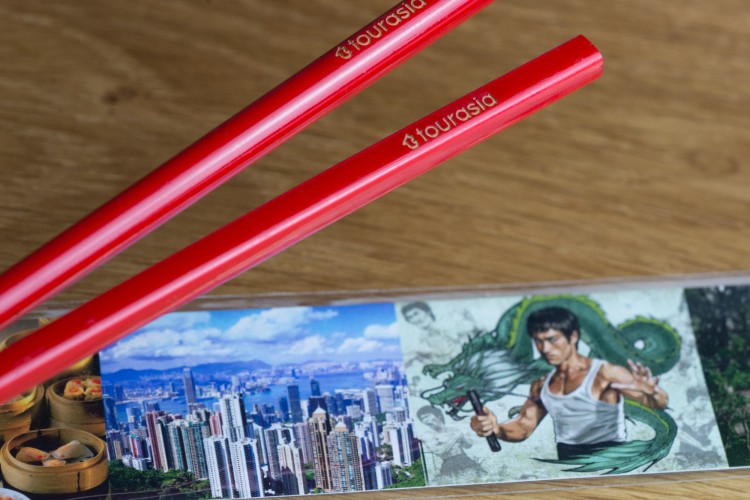 red chopsticks with logo for Tourasia