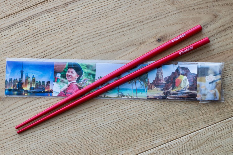 red chopsticks with logo for Tourasia